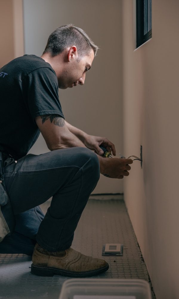 Sonoma Coast Electric Electrician Working on Wires in Wall